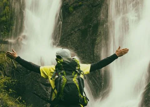 Man at waterfall background. Фото