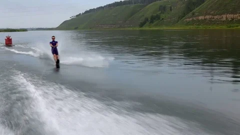 Man waterskiing on river Stock Footage 76608928
