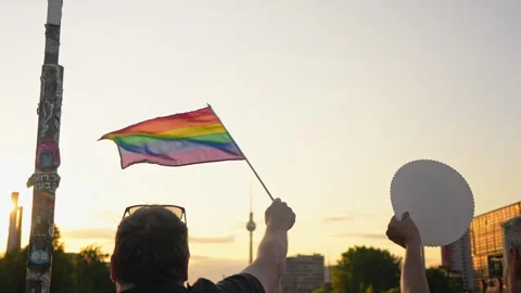 Man wave rainbow flag. Sunset silhouette Beautiful lgbt symbol. Gay pride parade Stock Footage 276588827