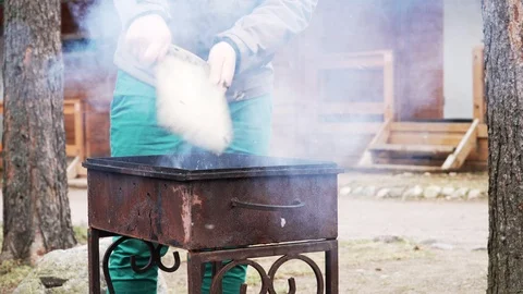 Man waves a board over burning coals in the grill Stock Footage 95130080