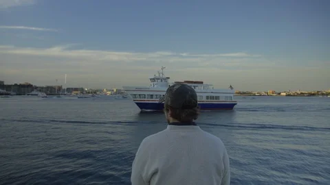 A man waves at a boat Stock Footage 127736922