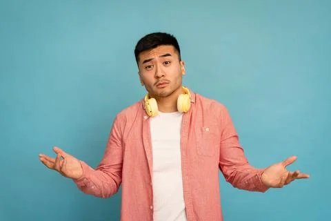 Man waves hands with doubtful expression. Stock Photos