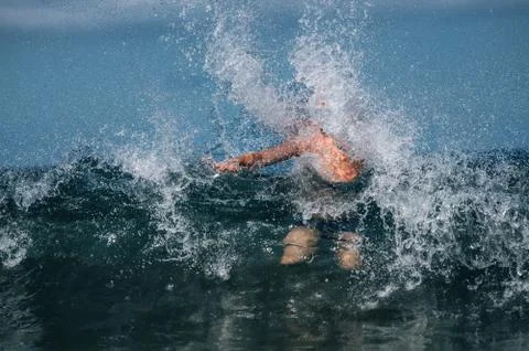 Man in waves of sea Stock Photos