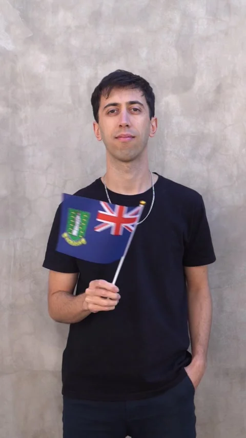 Man waving the British Virgin Islander flag in slow motion. Vertical shot. Stock Footage 340041647