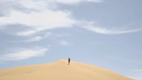Man waving on the desert Stock Footage 128617228