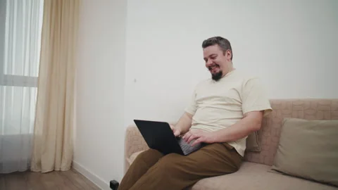 Man waving hand during video call on laptop computer Stock Footage 340929581
