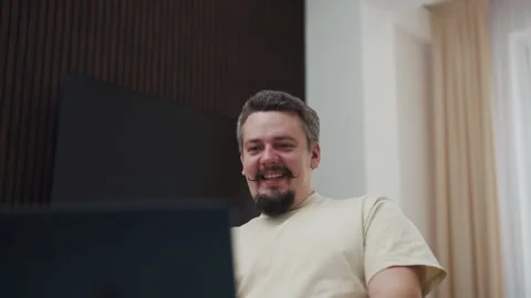 Man waving hand during a video call Stock Footage 340929638