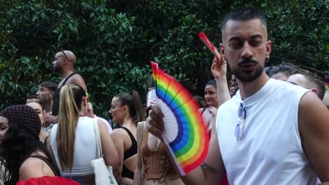 Man Waving Rainbow Hand Fan at Madrid Pride Parade (MADO) Video stock 339205276