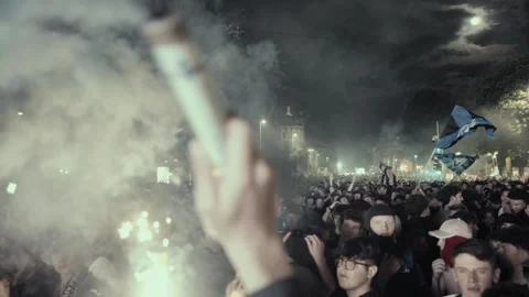 Man waving a smoke bomb, background of a huge crowd, Atalanta Europa League Stock Footage 276179451