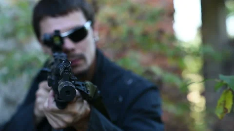 Man with weapon aims Stock Footage 60389280