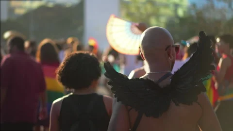 Man wear black angel wings at gay pride parade. Lgbtq community. Lgbt costume. Stock Footage 303493353