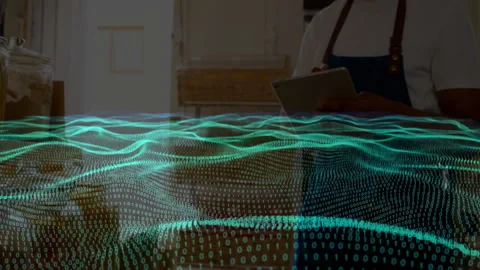 Man wearing apron tapping tablet and activating neon binary wave while reviewing Stock Footage 312758930