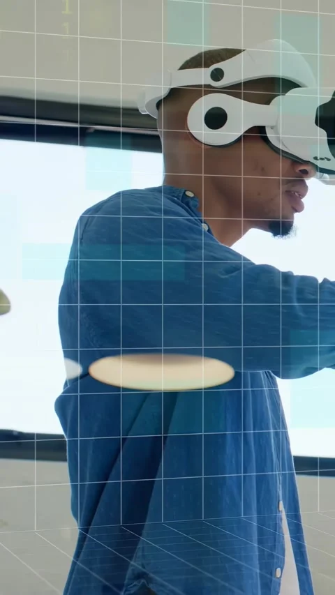 Man wearing AR headset by window, gesturing, creating grid overlay and falling Stock Footage 332506917