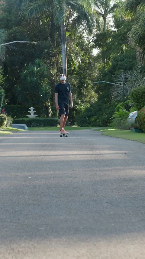 Man wearing augmented virtual reality goggles riding skateboard. Stock Footage 269987473
