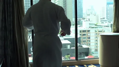 Man wearing bathrobe and dancing in front of the window, slow motion Video stock 88270961
