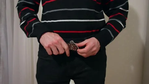 Man is wearing a belt Stock Footage 232945435