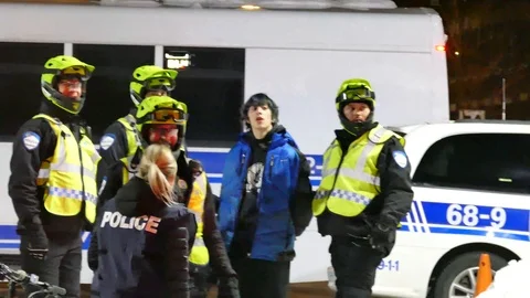 A man wearing a blue coat in custody Stock Footage 87750520