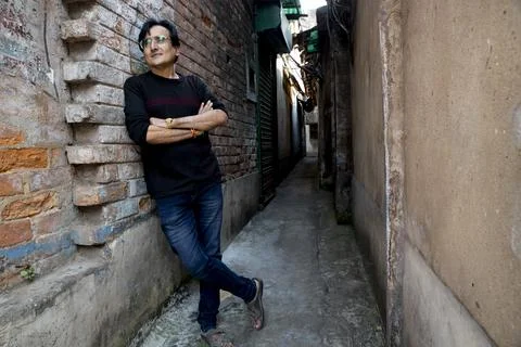 A man wearing a blue denim posing in the street Stock Photos