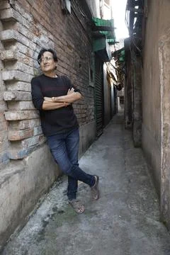 A man wearing a blue denim posing in the street Stock Photos