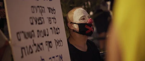 Man wearing a clown make up protesting Stock Footage 152848609