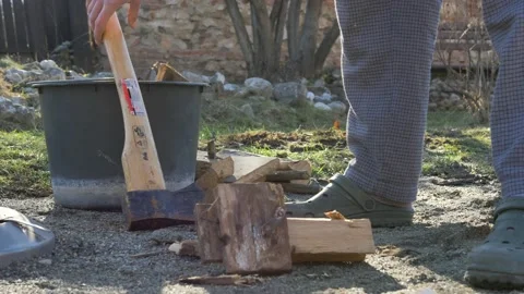 Man wearing Crocks puts Axe on ground Stock Footage 149892397