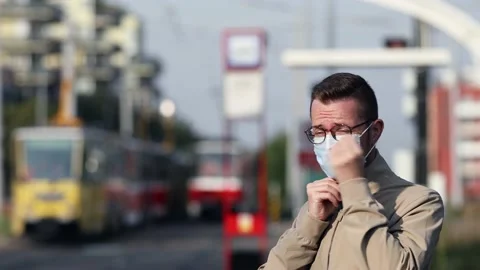 Man wearing face mask during waiting at tram station Stock Footage 139764126