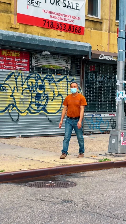 Man wearing face mask in front of closed storefront Stock Footage 331600399