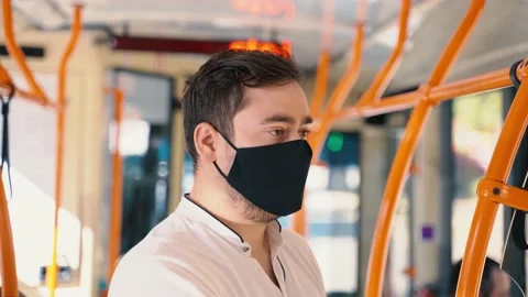Man wearing face mask inside public transport. Themes new normal Stock Footage 138342960