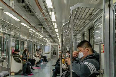 Man wearing face mask riding subway Stock Photos