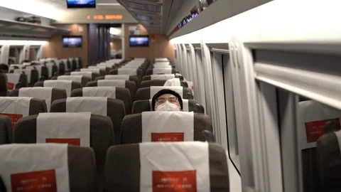 Man wearing a face mask in a train during COVID-19 outbreak in China Stock Footage 126313003