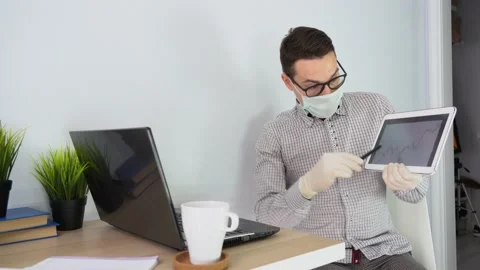 Man wearing face mask, uses laptop, talk online via video call, prices, pandemic Stock Footage 131473476