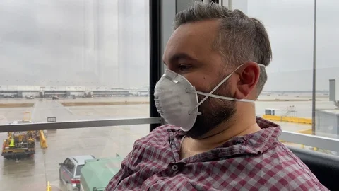 Man Wearing Face Mask Waiting to Board Plane during Global Pandemic Stock Footage 126663458