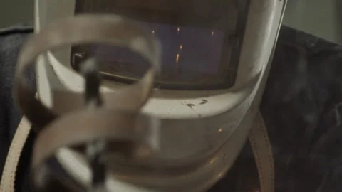 Man wearing a face shield while soldering metal Stock Footage 274948283