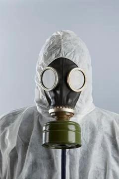 A man wearing a gas mask and protective suit Stock Photos