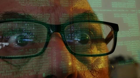 Man wearing glasses watching lines of code information scanning displayed on Stock Footage 342074910