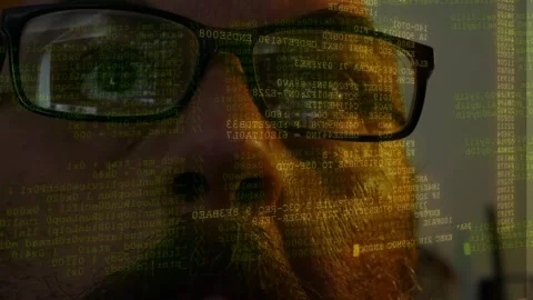 Man wearing glasses watching lines of code and data interface displayed on Stock Footage 342075293