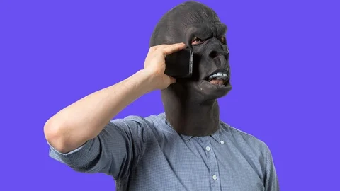 Man Wearing Gorilla Mask Using Megaphone in Cutout Poses Stock Footage 112708784