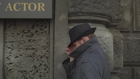 A man wearing a hat against the wall Stock Footage 72635185
