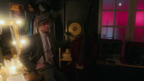 Man Wearing Hat and Posing With Upright Bass Backstage Stock Footage 312239585
