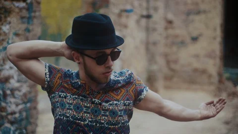 Man wearing hat dancing in an abandoned building Stock Footage 117916338