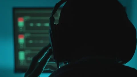 Man wearing headphone in dark control room or studio listening to conversation Видео 331308133