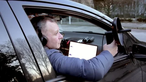 A man wearing headphones performs covert surveillance and records conversations Vidéo 329754326