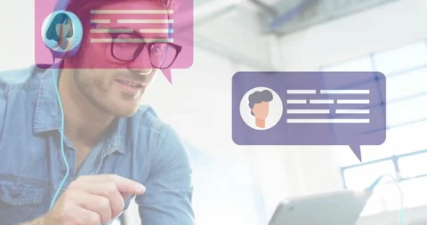Man wearing headphones tapping tablet screen, scrolling chat bubbles for Stock Footage 312415667