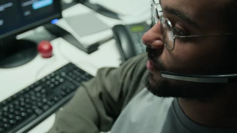 Man Wearing Headset Providing Customer Support in Office Stock Footage 346694652