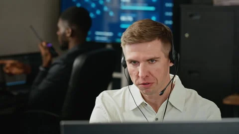 Man Wearing Headset Working at Computer in Cybersecurity Office Stock Footage 346817399