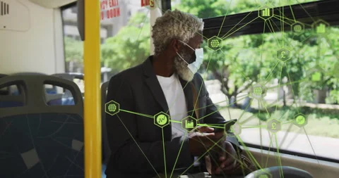 Man wearing mask sitting on bus seat, holding smartphone and showing green Video stock 307467718