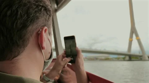 Man wearing mask using smartphone on public transport. Stock Footage 260894659