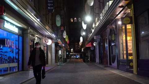 Man wearing a mask walks through the empty Melbourne city during the Stock Footage 149173585