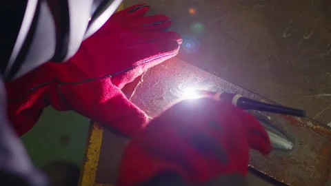 Man wearing mask welding in a workshop. Metal workers use manual labor. Skilled Stock Footage 157422405