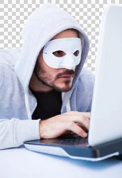 Man wearing mask while hacking into laptop Stock Photos